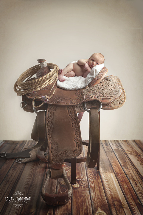 Baby Boy Cross, Ellensburg Newborn Photographer, photo of baby boy on his daddy's saddle