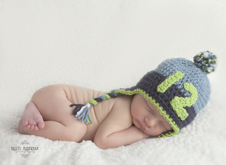 Baby Boy Cross, Ellensburg Newborn Photographer, photo of baby with seahawks hat sleeping