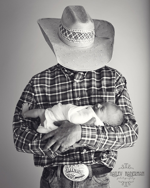 cowboy holding baby boy, rustic and natural posed newborn photography in Ellensburg WA by Hailey Haberman