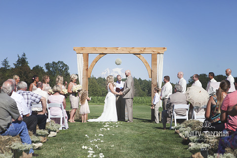 Nisqually Springs Farm Country Wedding Ceremony with gorgeous view MT Rainier behind couple 