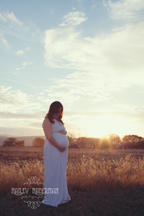 Fall Maternity Matt & Amy  Ellensburg Photographer expecting mom hugging baby bump in open field with dreamy backlight