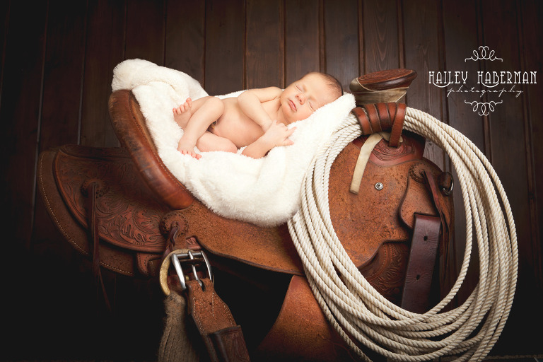 10 day old Baby Boy sleeping in daddy's western saddle