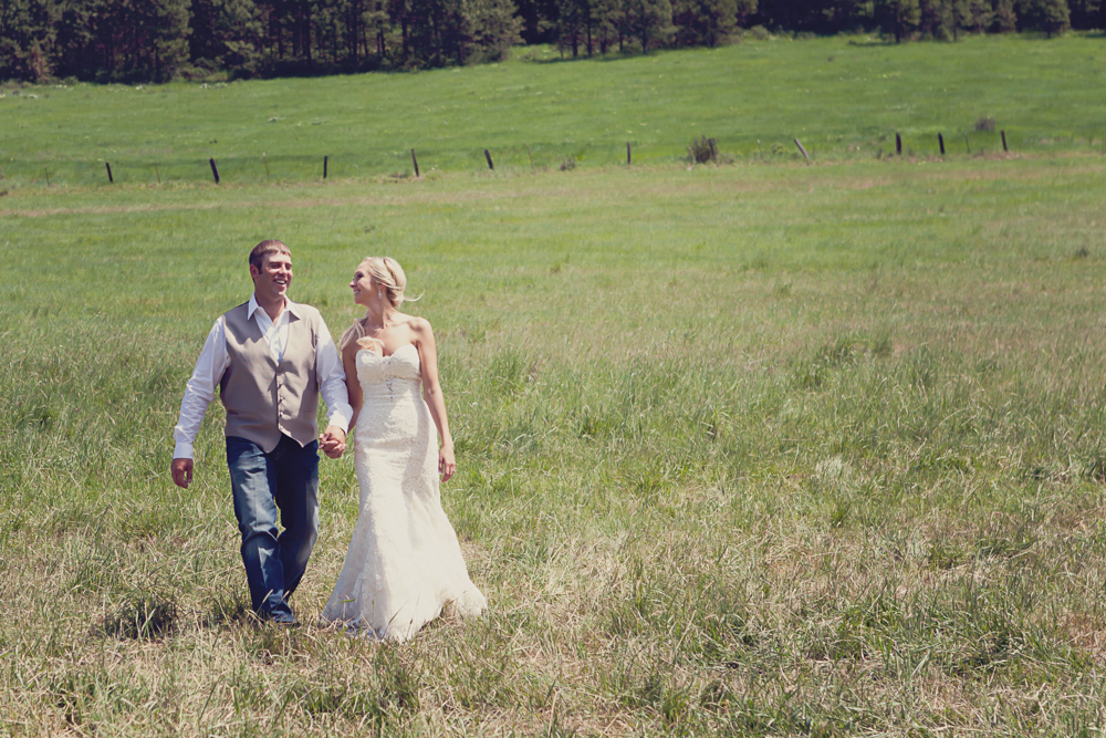 couple walking through open fields - ellensburg wedding photographer