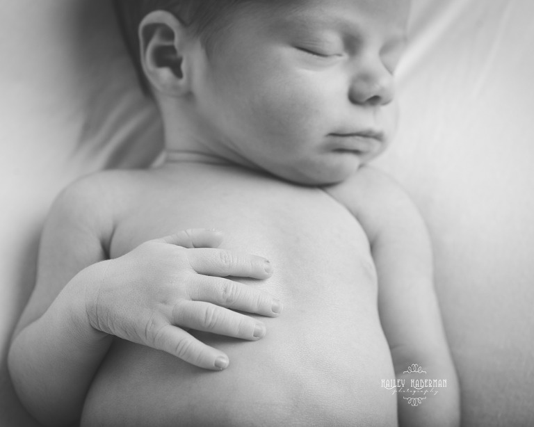 10 day old Newborn Baby Boy asleep in black and white in natural pose
