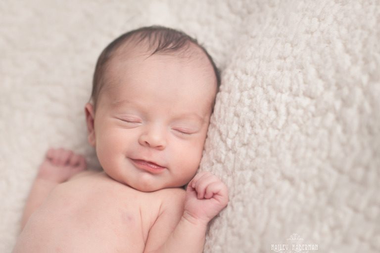 newborn baby girl sophia sleeping and smiling