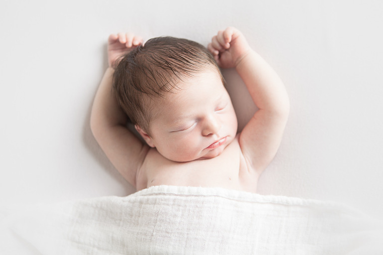 8 day old baby girl sleeping with hands above head - ellensburg baby photography