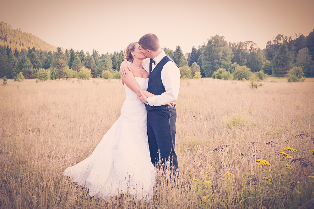 couple hugging in rustic open field - leavenworth wedding photography