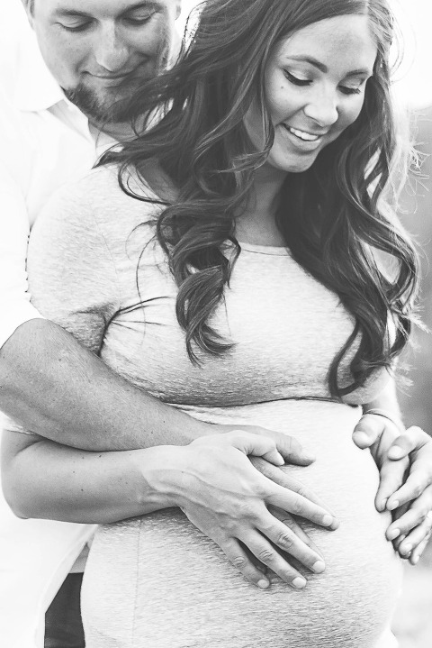 Ellensburg Fall Maternity Photographer captures expecting parents hugging baby bump in black and white