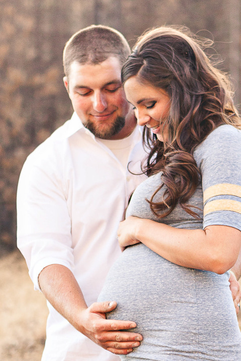 Ellensburg Fall Maternity Photographer captures expecting parents holding baby bump