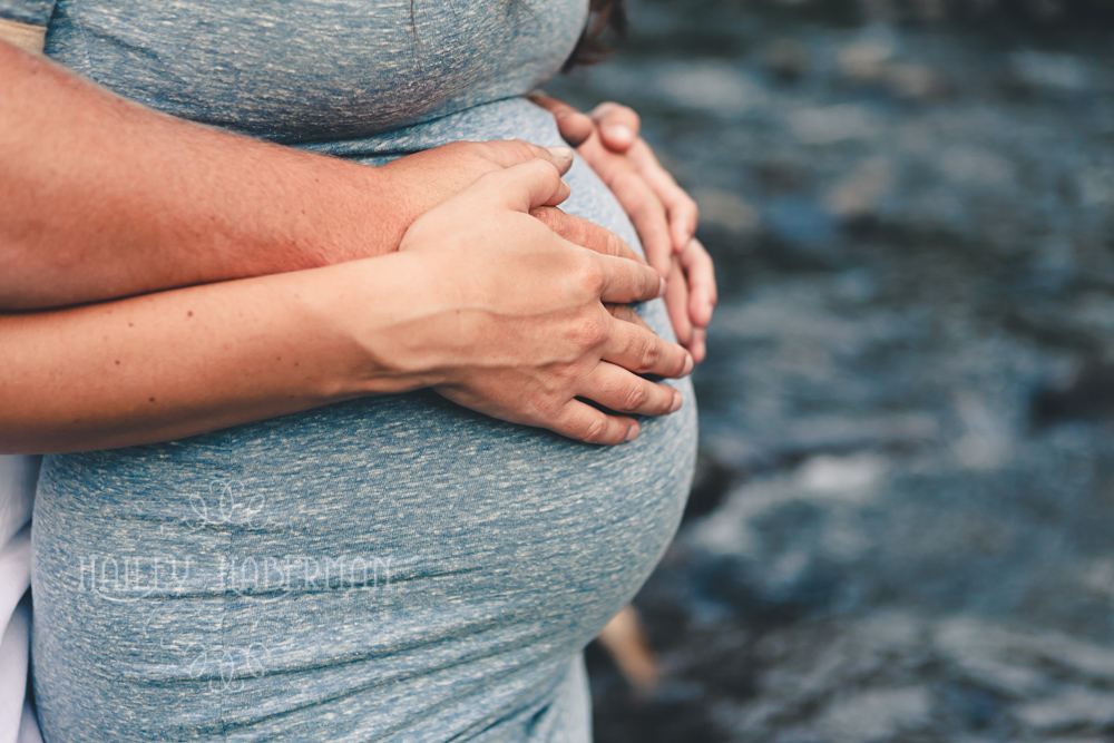 Ellensburg Fall Maternity Photographer captures expecting parents hands on baby bump