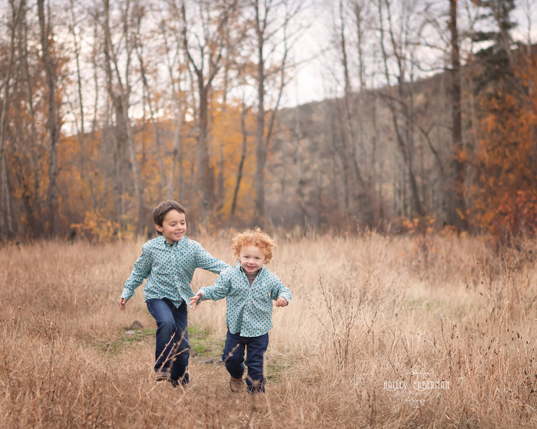 Fall lifesyle family session by Ellensburg Photographer Hailey Haberman with Russ and Danae photo of little boys running through open meadow