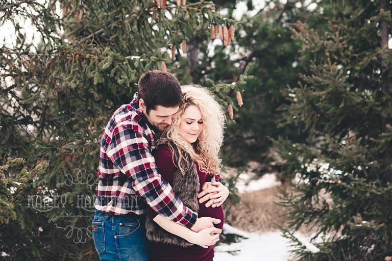 Frosty Winter Maternity with Jennie & Wesley by Ellensburg Newborn Photographer, photo of parents hugging around baby bump in winter snowy landscape