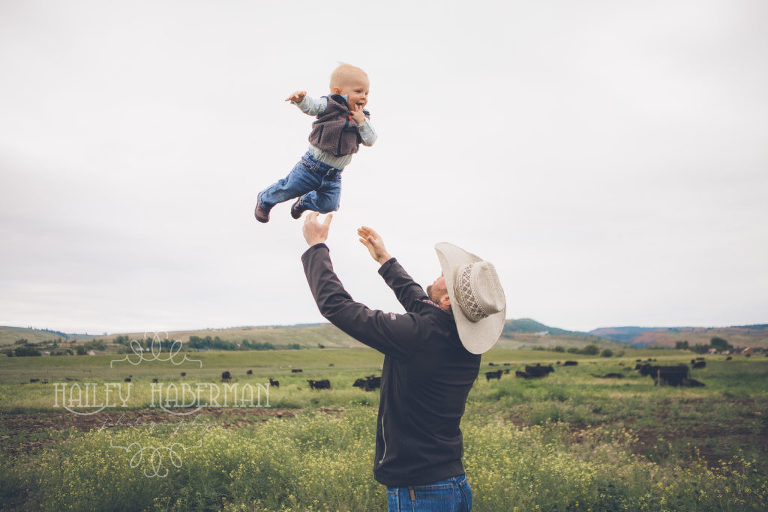Little Cowboy Royce by Ellensburg Baby Photographer Hailey Haberman being thrown in the air by his dad